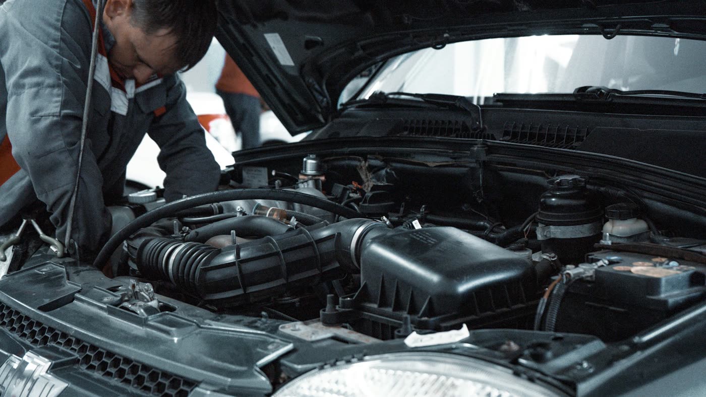 A mechanic working in an open engine bay